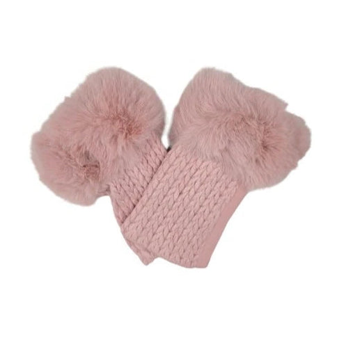 Pink knitted scarf with fluffy pom-poms on a white background