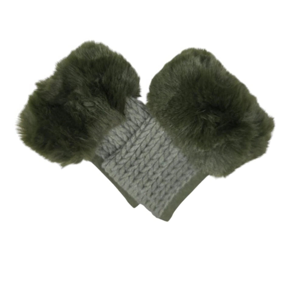 Pair of green mittens with fluffy pom-poms on a white background